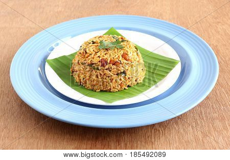 South Indian traditional and popular vegetarian rice dish, puliyogare, made from rice and a paste containing tamarind and other ingredients.
