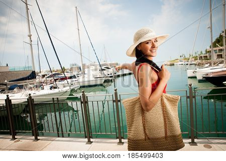 Wman Walks A City On The Beach On Hot Summer Day Un Beautiful Red Dress With Hat.