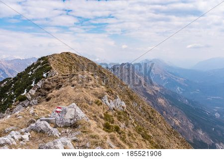 At the summit of Monte Chiampon in Italy view to Julian Alps in spring