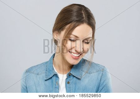 Photo Of Good-looking Woman Dressed Casually Isolated On Gray Background With Eyes Looking Down In S
