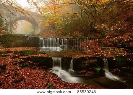 Autum colors waterfalls and bridge in Rodopi mountain