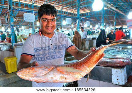 Bandar Abbas Hormozgan Province Iran - 16 april 2017: An Iranian man shows a large fish in a covered fish market.