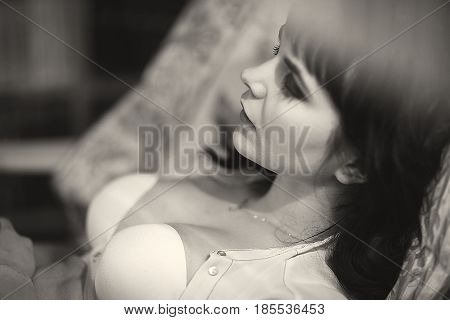 Sexy Brunette Resting In Chair At Home. Black And White Closeup Portrait Shot. Wearing White Bra And