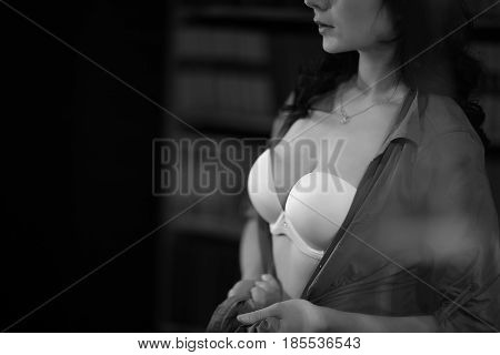 Unrecognizable Brunette At Home, Evening. Black And White Portrait Shot. White Bra Black Shirt