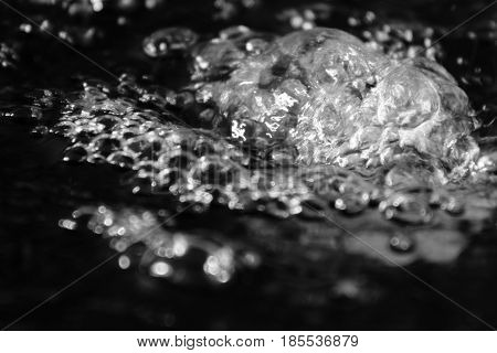 Abstract splashes of water on a black background.