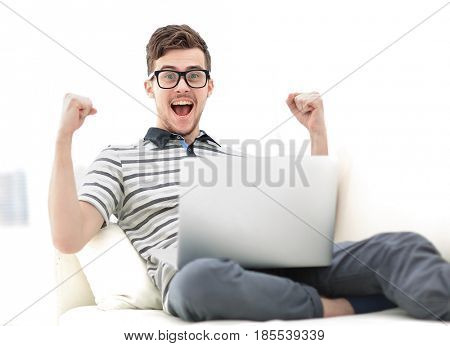 Man Relaxing on Sofa with Laptop Computer