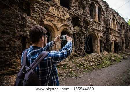 tourist taking picture of ruins Tarakanovskiy fort