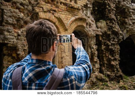 tourist taking picture of ruins Tarakanovskiy fort