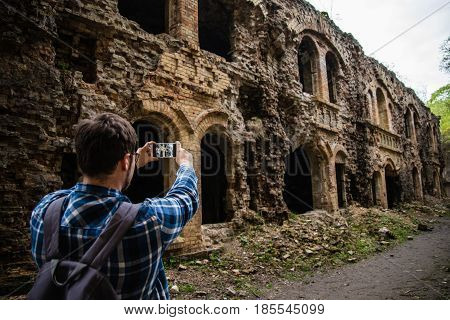 tourist taking picture of ruins Tarakanovskiy fort