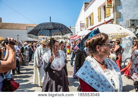 Saintes-Maries-de-la-Mer, France - May 25, 2015. Religious feast in honor of the Holy Maries in Provence. Women in vintage dresses and with umbrellas. The concept of ethnographic tourism