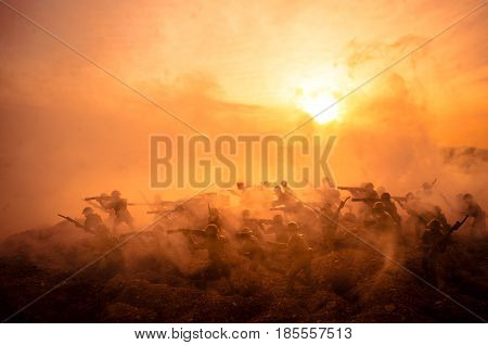 War Concept. Military silhouettes fighting scene on war fog sky background World War Soldiers Silhouettes Below Cloudy Skyline At night. Attack scene. Armored vehicles. Tanks battle. Decoration