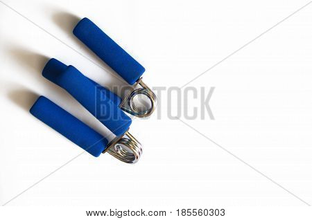 Hand blue expander isolated. Sport equipment for gym
