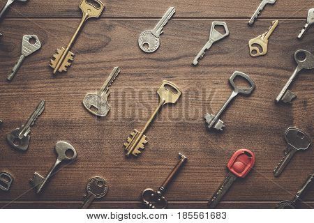 overhead of many different keys in oder on wooden background concept