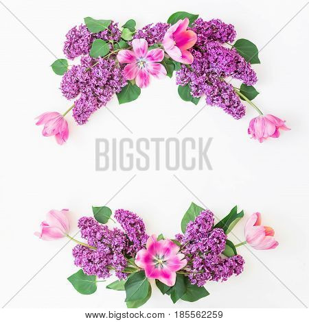 Floral pattern of lilac branches, tulips and leaves on white background. Flat lay, top view. Flower pattern