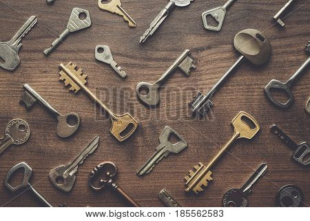 overhead of many different keys in oder on wooden background concept