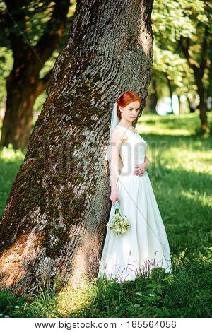 Young Beautiful Blonde Woman In Blooming Garden. Bride.