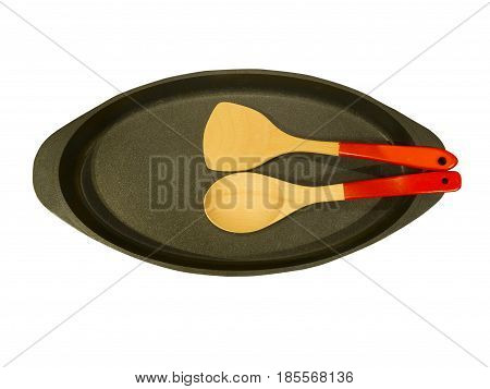 Empty modern frying pan with wooden utensils. isolated on white background. Top view.