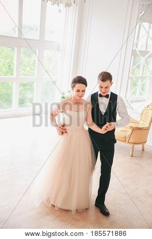 first wedding dance.wedding couple dances on the studio. Wedding day. Happy young bride and groom on their wedding day. Wedding couple - new family. Wedding dress.