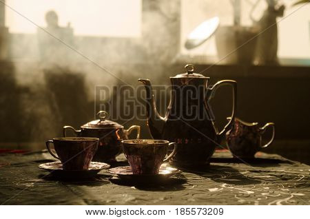 Food Background Tea And Coffee Theme. Old Vintage Ceramic Tea Or Coffee Pot With Cups Jug And Sugar