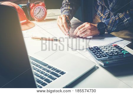 Architect Or Engineer Working In Office On Blueprint. Architects Workplace , Blueprints, Ruler, Helm