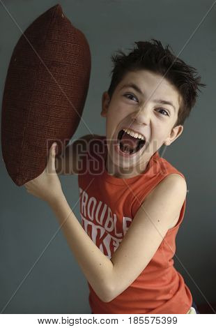 Teenager Mischivous Boy Fighting With Pillow Open Mouth