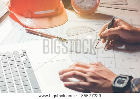 Architect Or Engineer Working In Office On Blueprint. Architects Workplace , Blueprints, Ruler, Helm