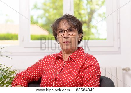 portrait of mature woman with a red shirt with white dots