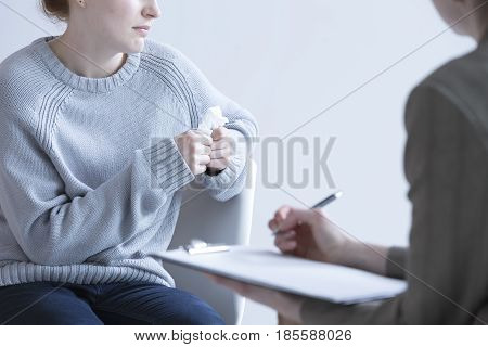Crying woman suffering from depression and her psychologist