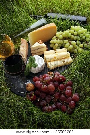 Cheese Platter And Wine With Different Cheese And Grapes