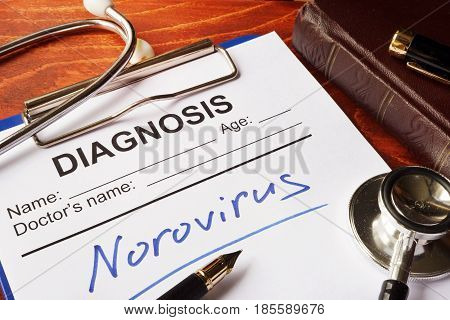 Medical form with diagnosis Norovirus on a table.