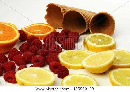 Cones And Colorful Various Fruits Raspberry ,lemon ,orange Slice Setup On White Background . Summer