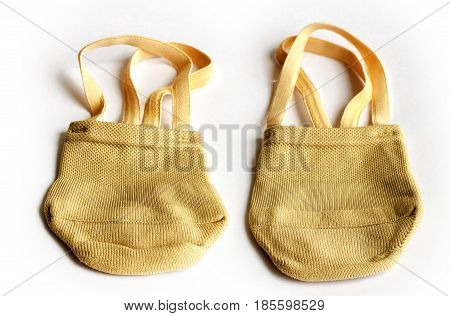 Rhythmic gymnastics shoes worn on white background.