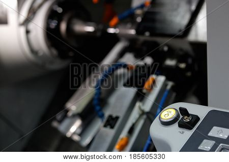Close up of cnc turning lathe machine. Selective focus on OK push button.