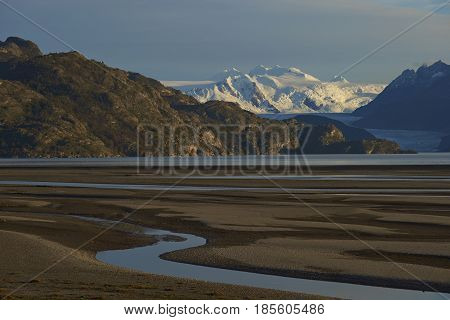 Lago Grey surrounded  mountain peaks in Torres del Paine National Park in Patagonia, Chile. Glacier Grey in the distance.