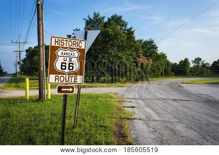 Historic Route 66 road sign in a stretch of the original road in the State of Kansas USA; Concept for travel in the USA and Road Trip