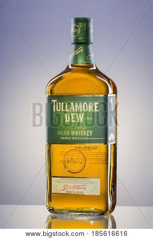 Tullamore Dew whiskey on gradient background. Tullamore Dew is blended Irish whiskey produced by William Grant and Sons since 1829.