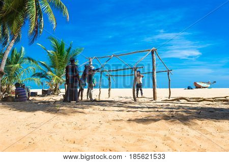 SRI LANKA - Mach 23: Local fishermen pull a fishing net from Indian Ocean on Mach 23, 2017 in Kosgoda, Sri Lanka. Fishing in Sri Lanka is the way they earn their living.