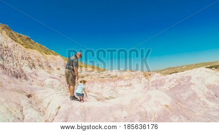 Little girl on a weekend hike with her dad in Paint Mines Interpretive Park in Colorado.