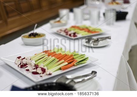 Veggie salad mix, celery and carrot sticks on white table healty dinner