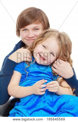 Big brother teen holds the hands of his beloved younger sister.Isolated on white background.