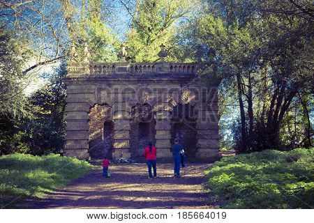 Bristol UK - April 02 2017:Familly walking to see the Vanbrugh's Echo pavilion showing the lost statue at the centre. The Echo is a loggia at the end of the southeast axis of the Kings Weston house in Bristol Uk