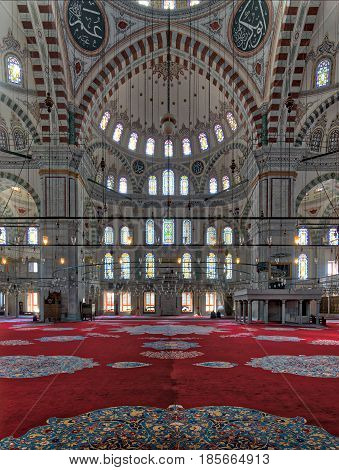 Istanbul, Turkey - April 20, 2017: Fatih Mosque a public Ottoman mosque in the Fatih district of Istanbul Turkey with a huge arches decorated domes and colored stained glass windows