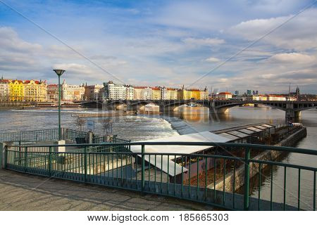 Prague Czech Republic - March 20 2017: View on the Prague panorama with Jirasek bridge at sunset.The Prague bridges arching over the Vltava River are not only vital connecting links but also valuable works of architecture .