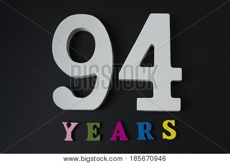 Letters And Numbers Ninety-four Years On A Black Background.