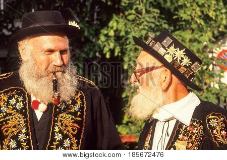 Two Man Speaking Dressed In Traditional Swiss Costume