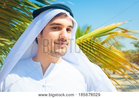 arabian man with palm tree in the background