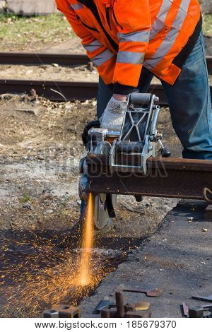 BERLIN - APRIL 21: Working Deutsche Bahn demonstrates working with cutting machine. Spring Festival Exhibition in the Rail yard Schoeneweide April 21 2013 in Berlin Germany