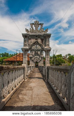 The bridge over the pond. Architectural wonders at the Karangasem water temple in Bali, Indonesia.