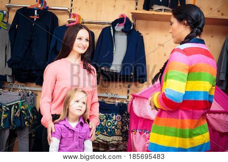 mother and daughter shopping at children's store