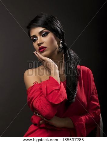 young attractive brunette posing make-up in red shirt
